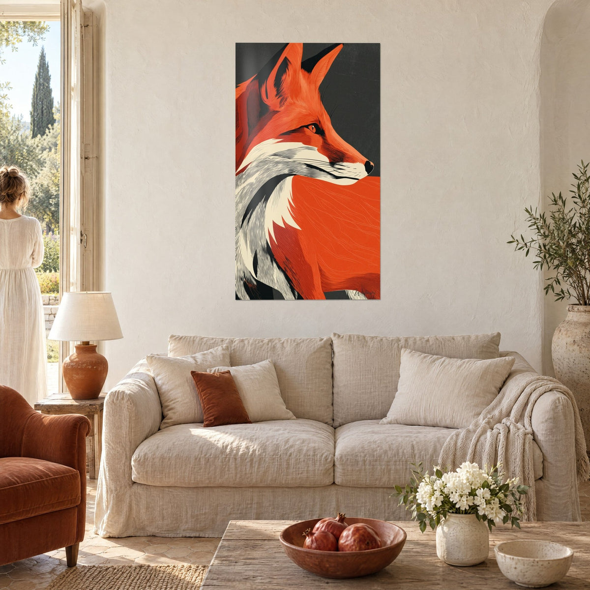 Wall art red fox gazing toward the horizon, bright orange coat and charcoal background, above a sofa in a bright living room