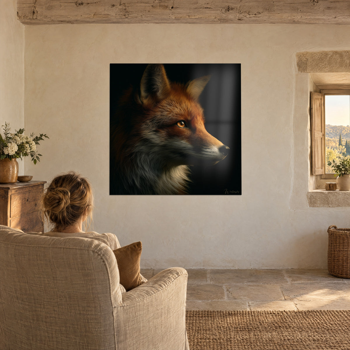 Wall art blazing fox head, ears pricked up, dark background, a woman seen from behind in a beige armchair, window overlooking the countryside