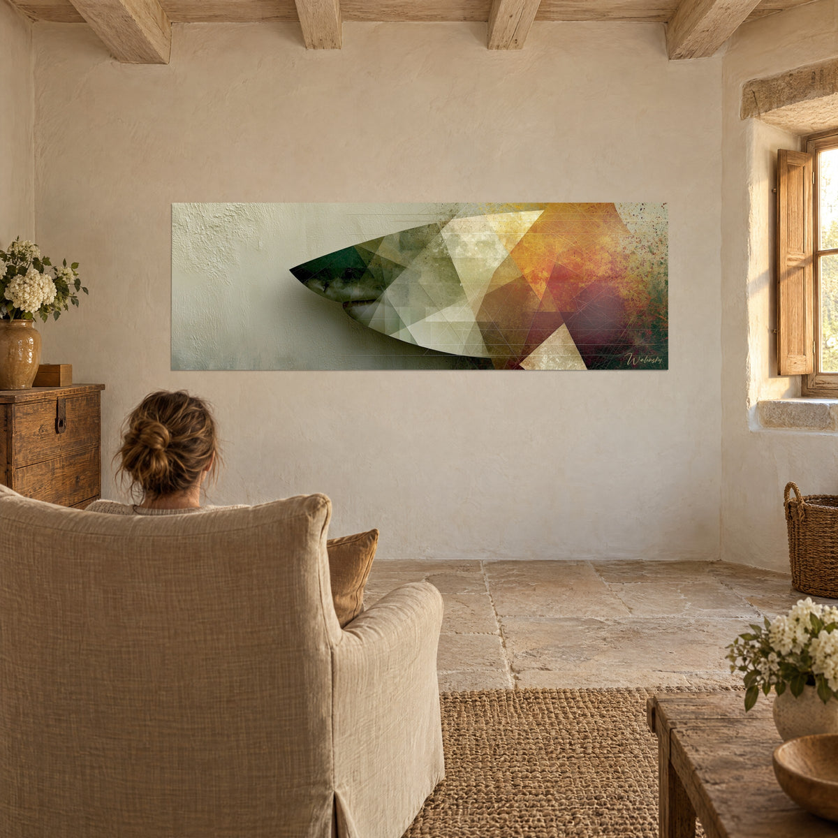 Wall art large geometric great white, forest green, golden ochre and burgundy triangles, viewed from behind an linen armchair