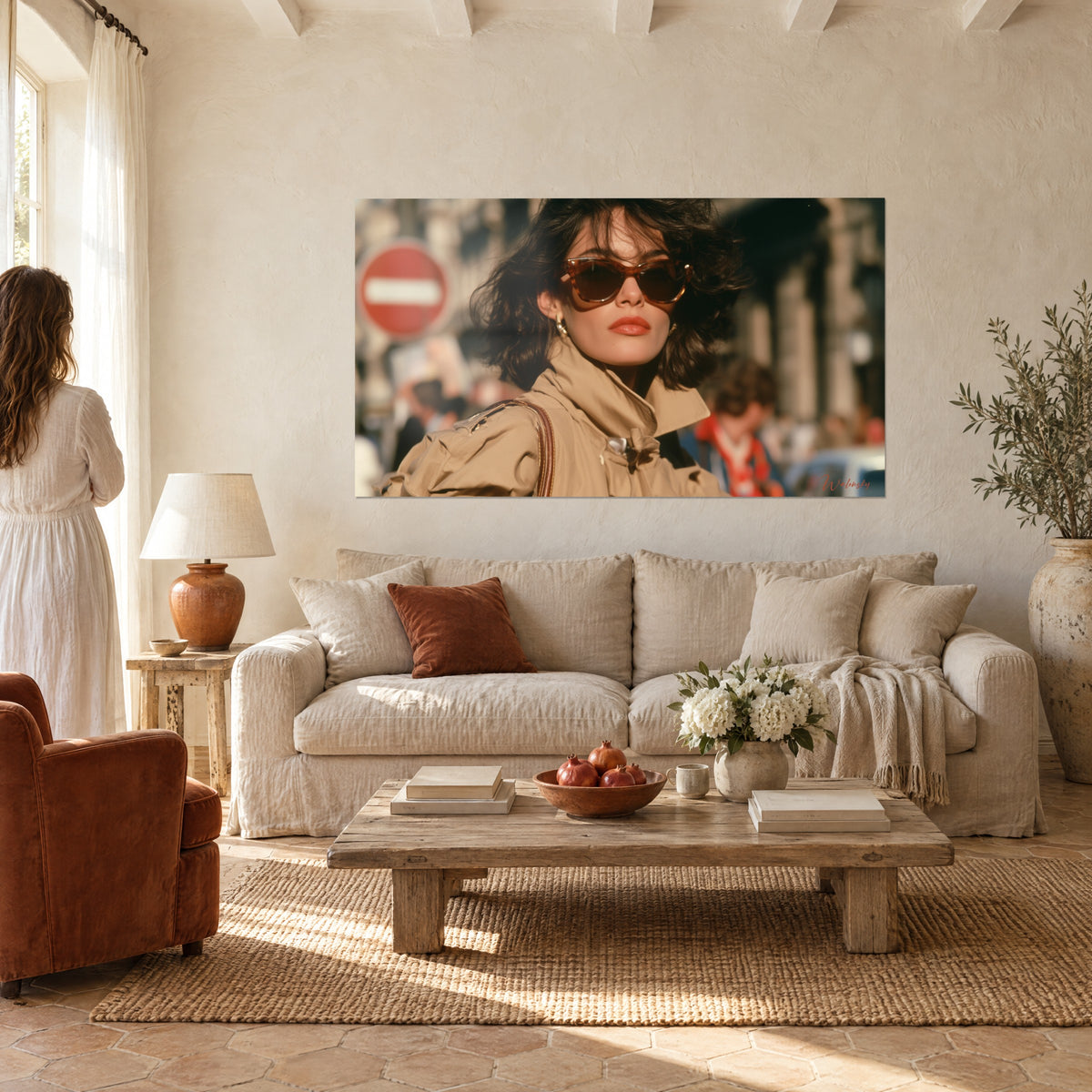 Cuadro mujer morena con gafas de carey y gabardina beige, señal de tráfico roja desenfocada, sobre un sofá en un salón luminoso