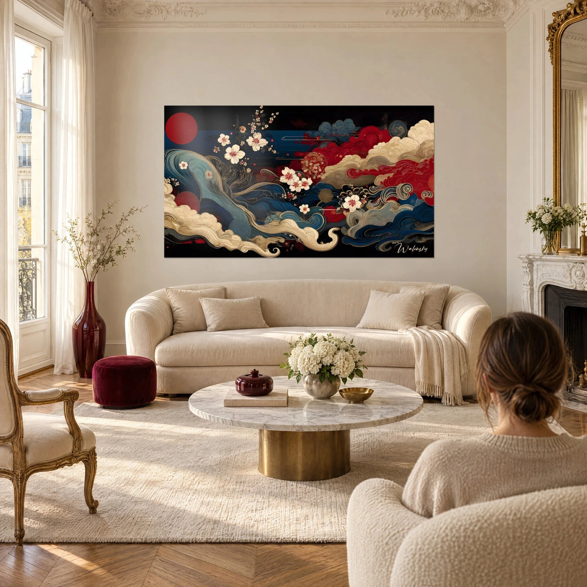 Wall art with Japanese-inspired midnight blue waves and red clouds, ivory cherry blossoms, above a sofa in a bright living room