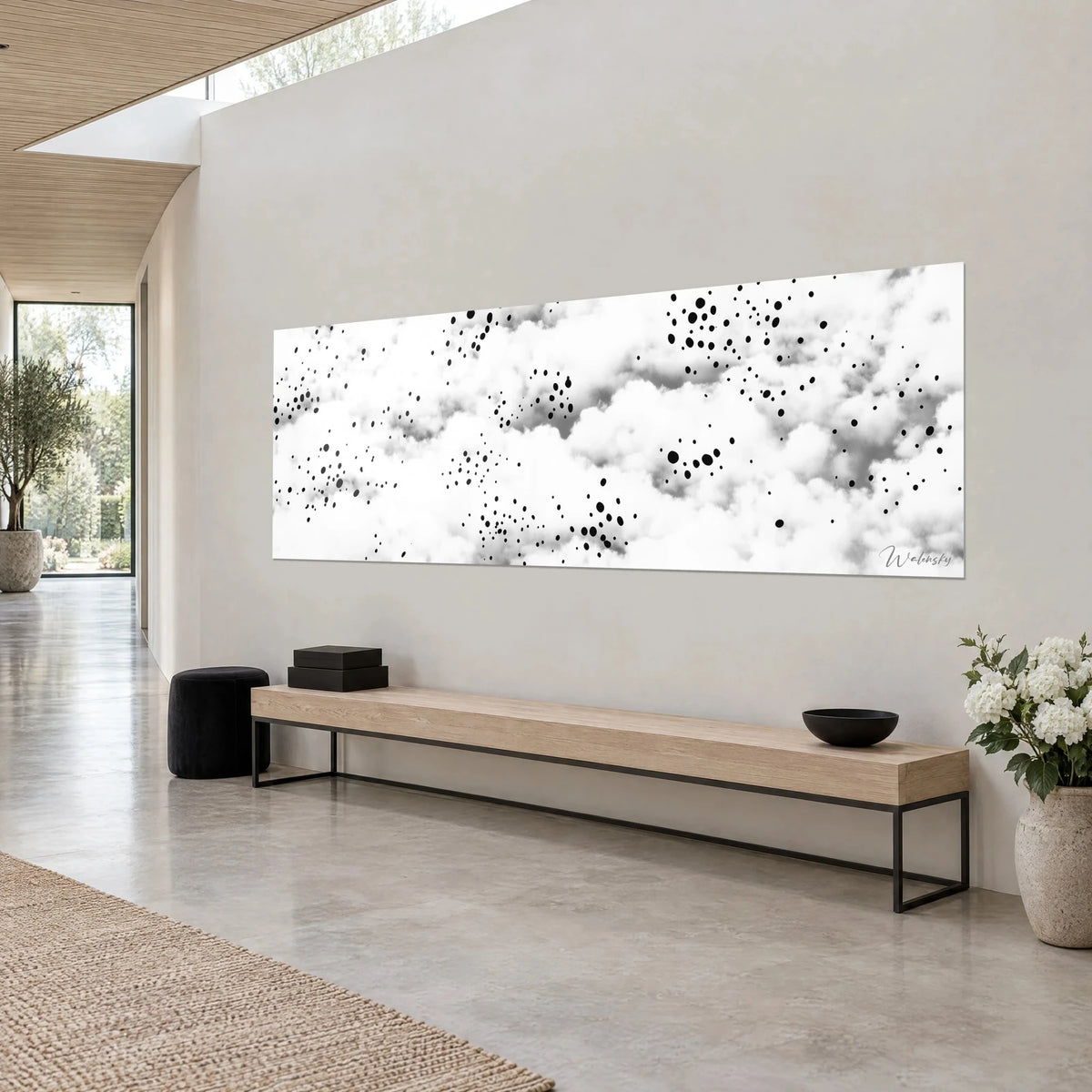 Wall art panoramic view of a fluffy ivory and ash grey sky dotted with black drops, three-quarter view, low oak and concrete bench