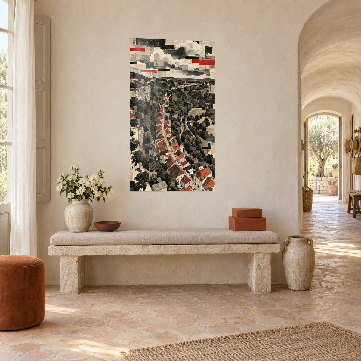 Wall art of a lane lined with red roof tiles in a collage of black and cream papers, hung on a white wall of a country house, stone bench
