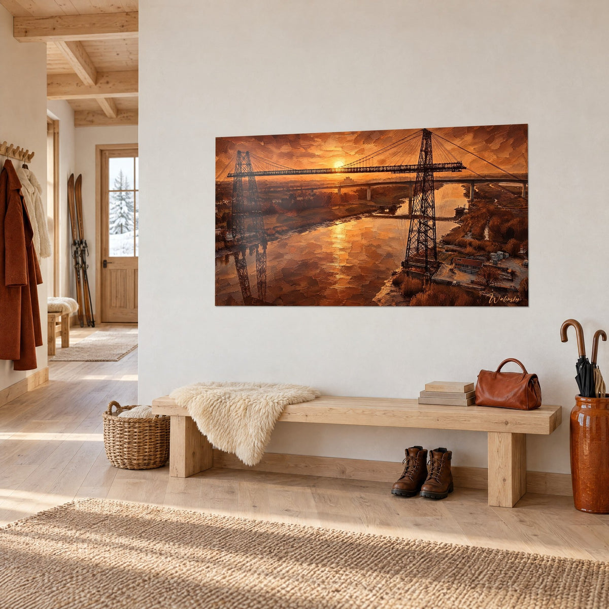 Wall art transporter bridge rising over copper-toned water, blazing brown and orange sky, hung in a light wood entryway