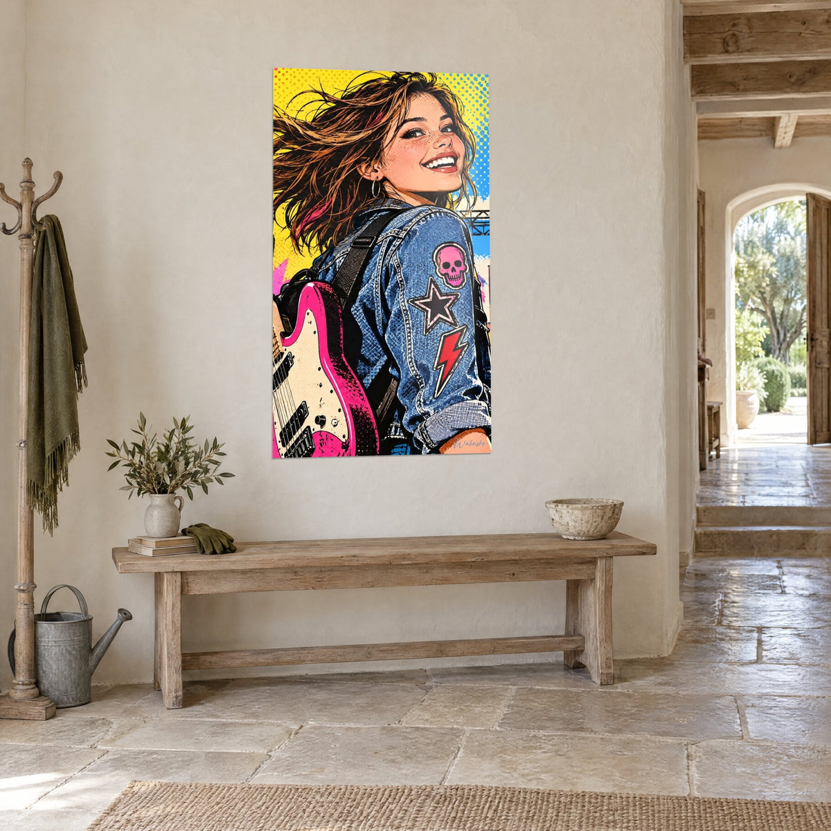 Tableau rockeuse aux cheveux châtains au vent, veste denim à écusson tête de mort rose, sur un mur de pierre claire, vue de trois-quarts