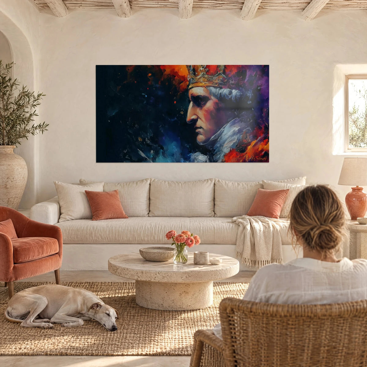 Wall art of a crowned king in profile, grey wig and orange and violet clouds, above a sofa in a bright living room
