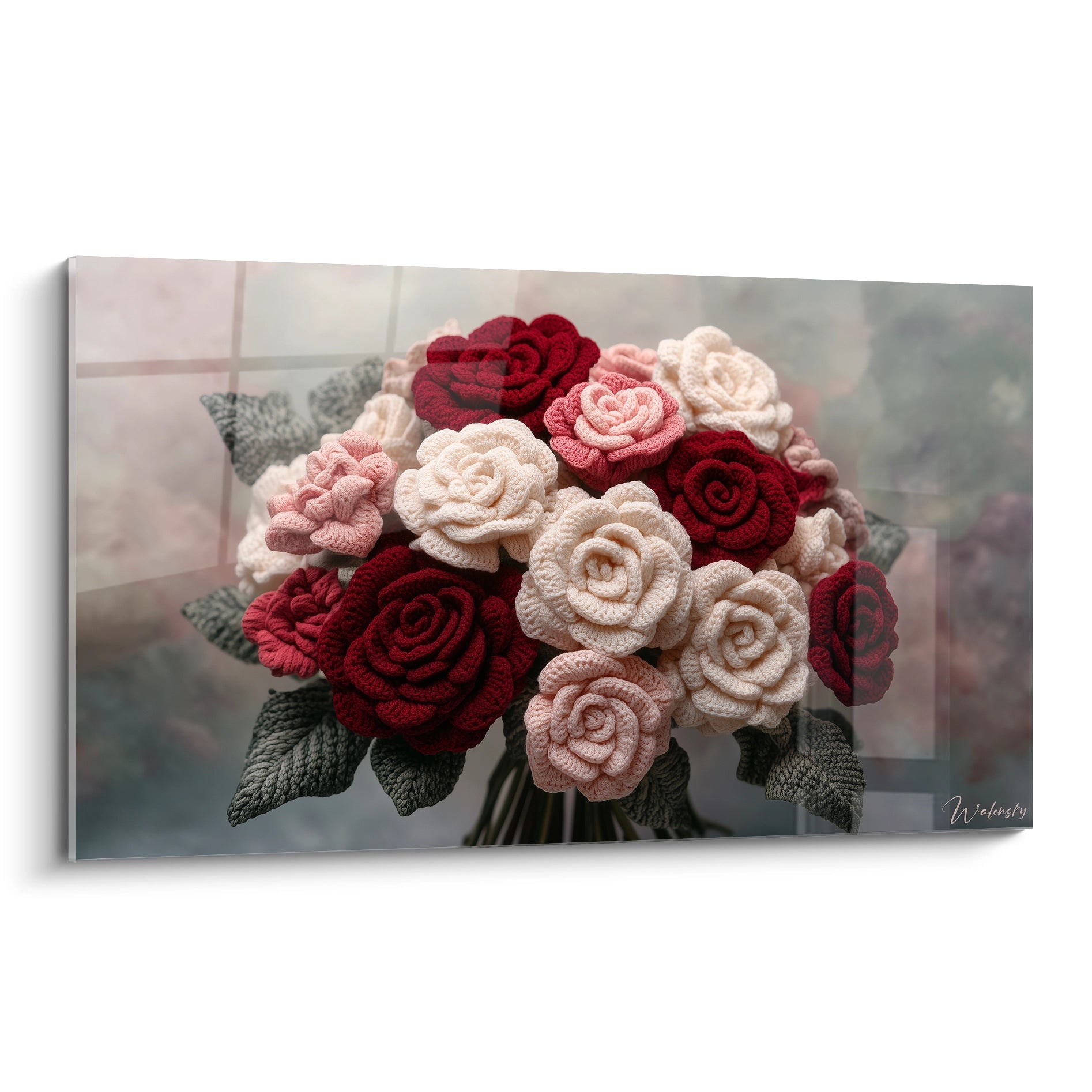 Un tableau crochet présentant un bouquet de roses en fils textiles, composé de fleurs rouges profondes, blanches pures et roses pâles, avec des feuilles vert-gris, arrangées en composition dense et harmonieuse sur fond neutre.
