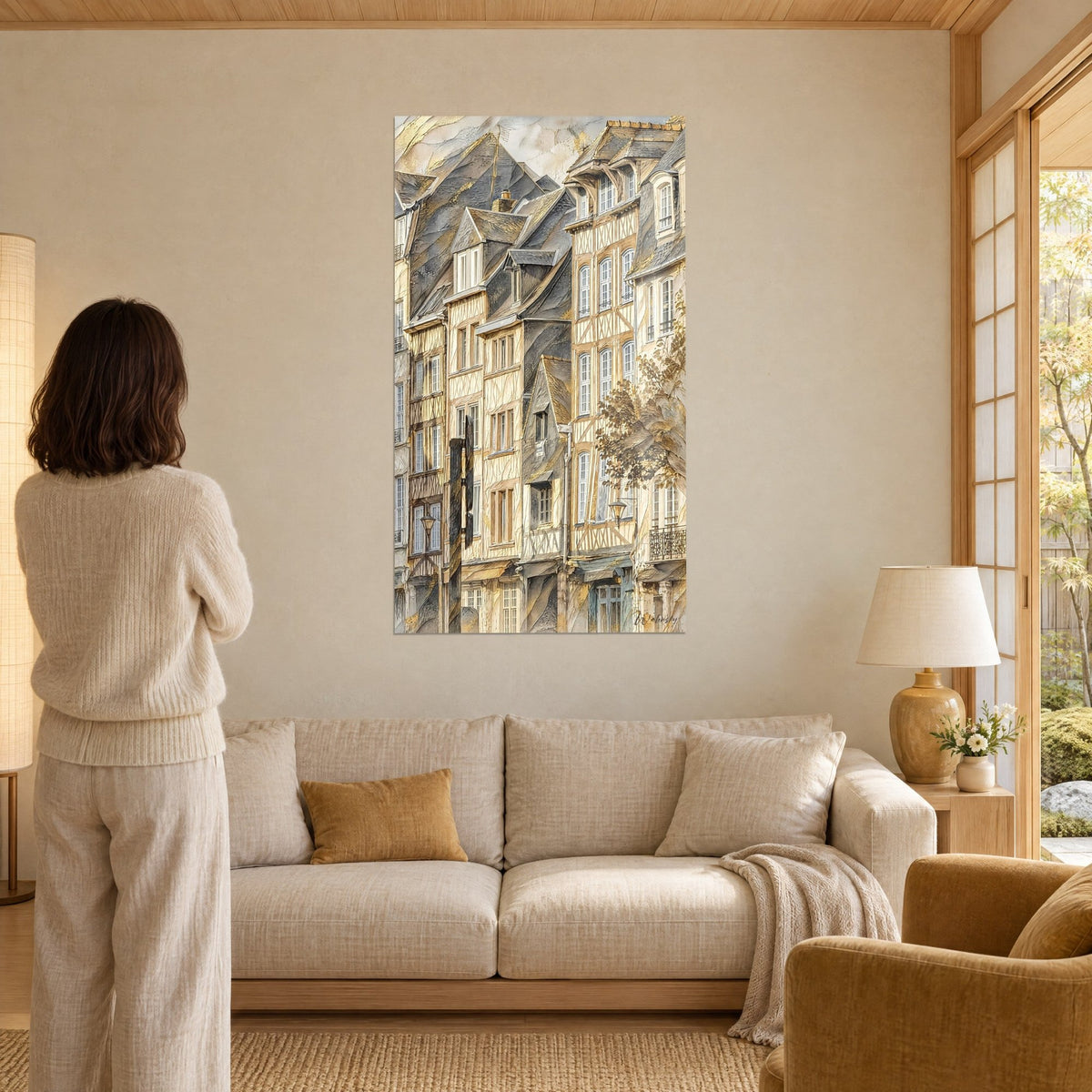 Tableau façades médiévales à colombages ocre et crème, toits d'ardoise gris dorés, au-dessus d'un canapé dans un salon lumineux