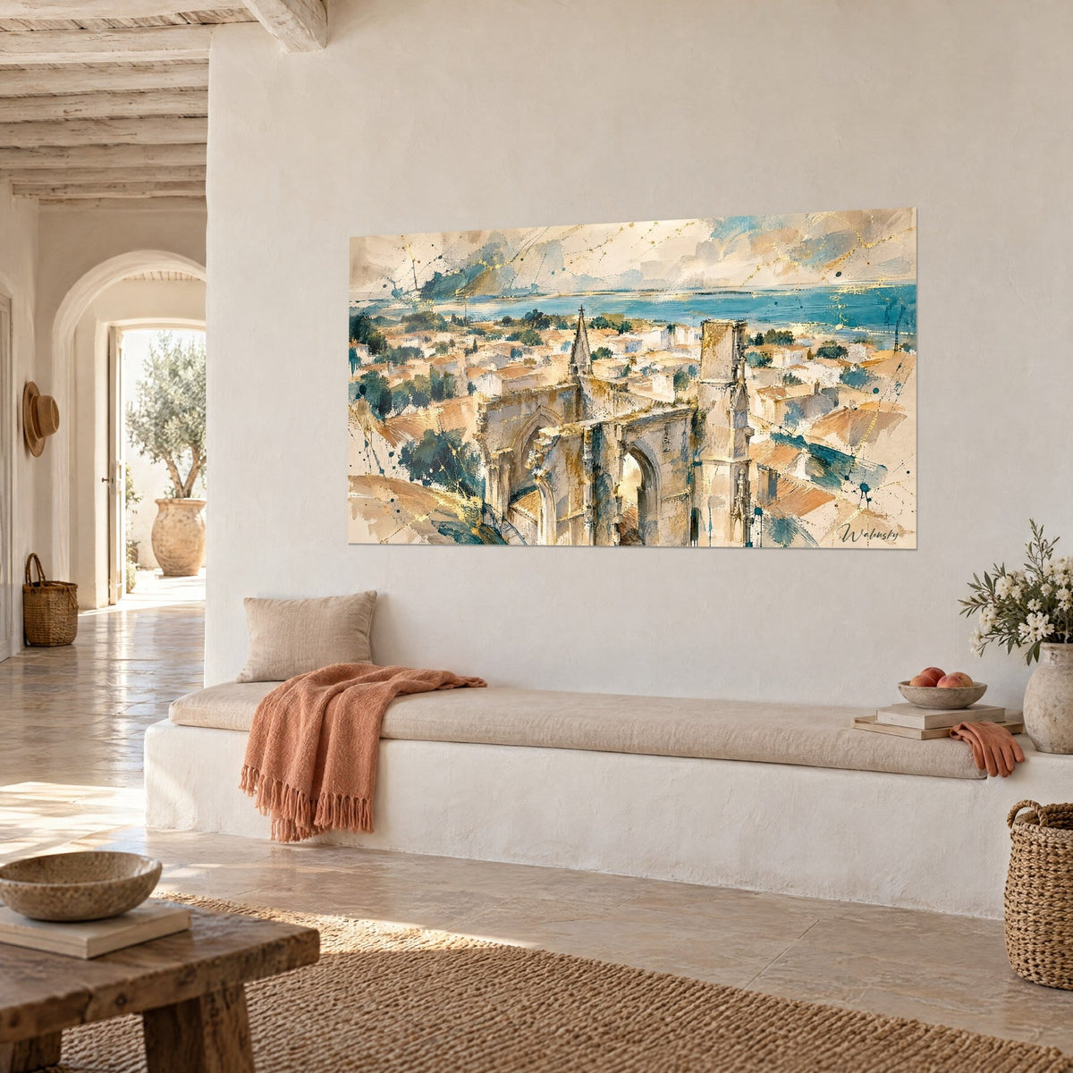 Wall art watercolour of a ruined cathedral, terracotta-toned roofs and blue sea, three-quarter view, lime wall and bench