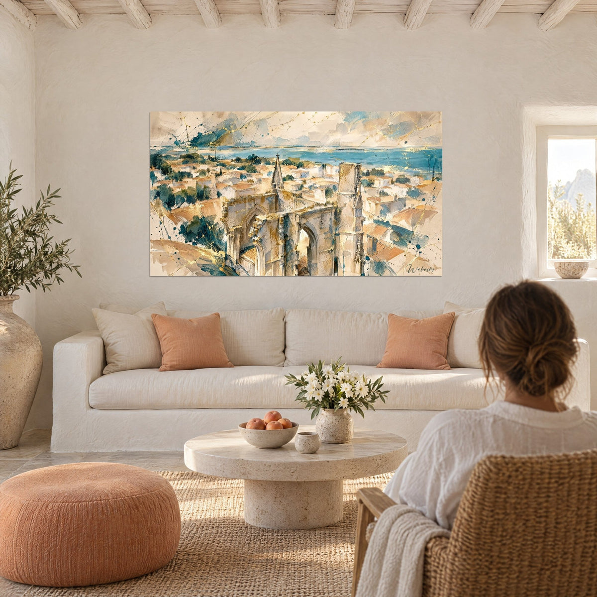 Wall art Gothic ruins in ochre and turquoise overlooking a bay, woman seen from behind, above a sofa in a bright living room
