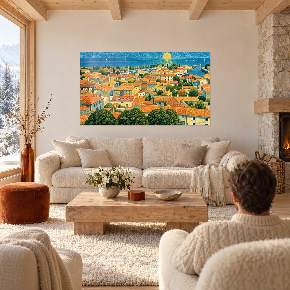 Wall art coastal village with orange rooftops under golden sun, deep blue sea and sailboats, above a sofa in a bright living room
