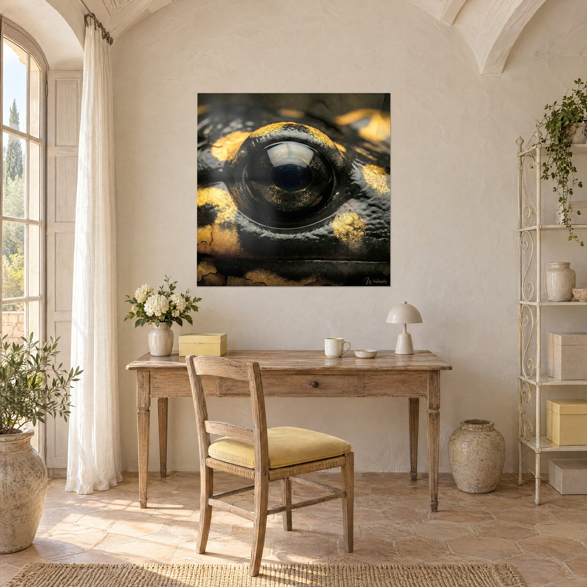 Wall art salamander iris with gold glitter on a deep black background, hung above a light wood desk, chair with a yellow cushion