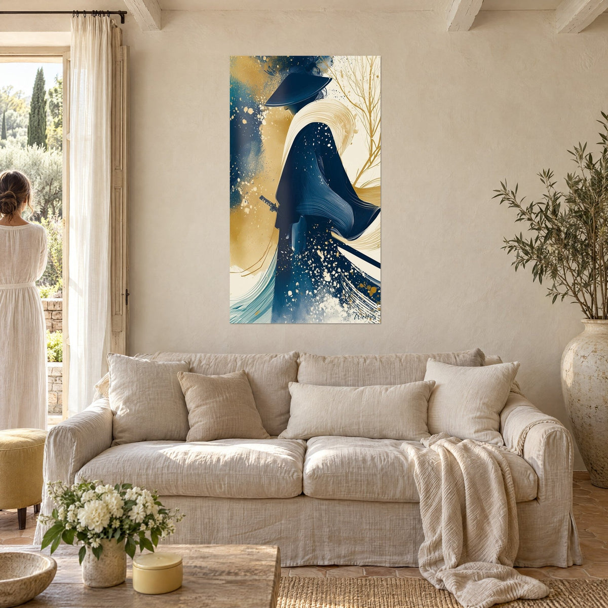 Wall art of a warrior in a conical hat, swirling navy and gold cloak, bare branches, above a sofa in a bright living room