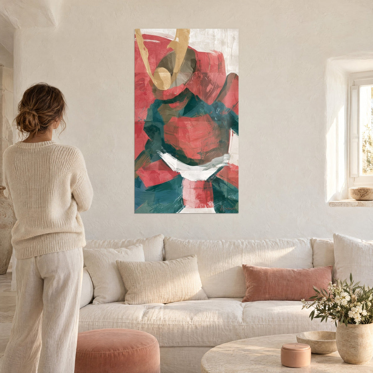 Wall art samurai helmet with golden horns, coral red and petrol blue flat color fields, woman seen from behind, above a sofa in a bright living room
