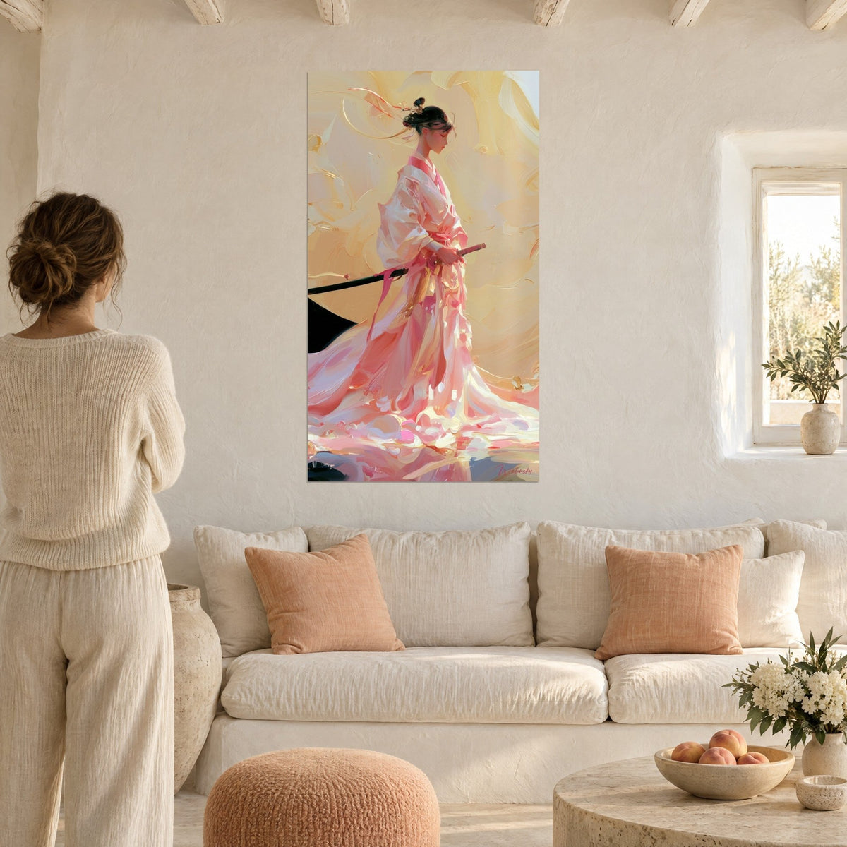 Wall art of a female warrior in pale pink and gold kimono, black katana at the hip, hung above a sofa in a bright living room