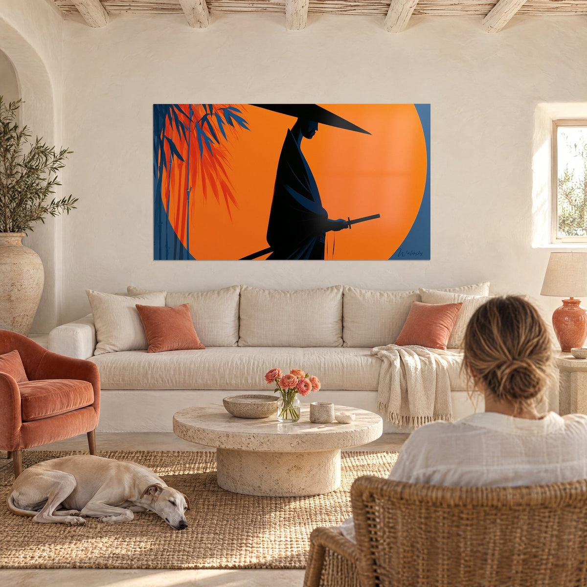 Wall art samurai in black silhouette under a conical hat, orange sun disc and blue bamboo, above a sofa in a bright living room