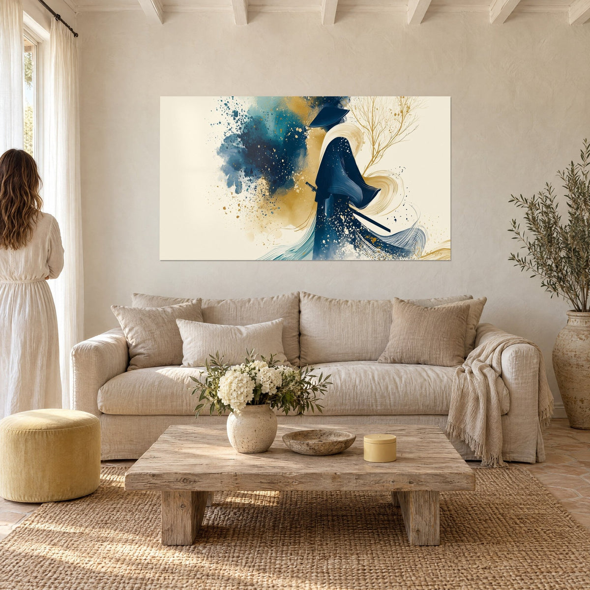 Wall art samurai in navy blue kimono under a conical hat, gold ink splashes, above a sofa in a bright living room