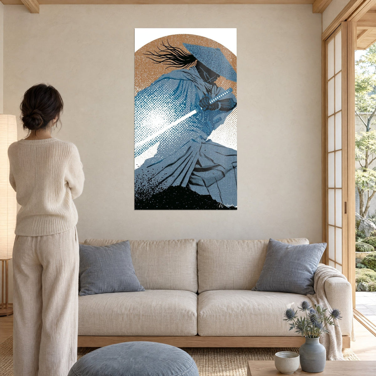 Wall art of a samurai in a blue straw hat drawing a white blade, ochre background, above a sofa in a bright living room