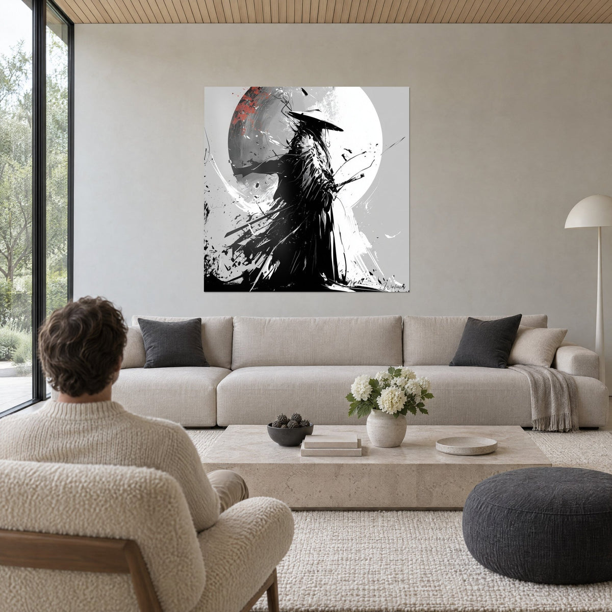 Wall art of a warrior in a conical hat, torn black kimono before a white disc, red splashes, above a sofa in a bright living room