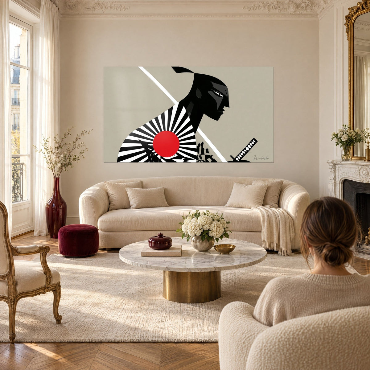 Wall art of a samurai in black-and-white profile, large red disc over a radiating fan, above a sofa in a bright living room