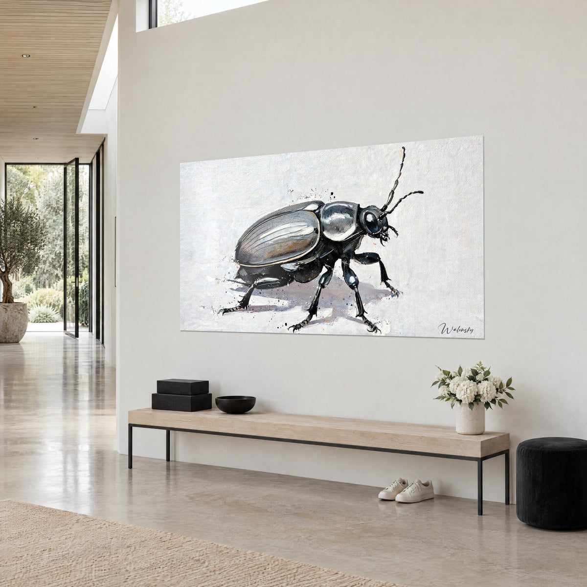 Wall art glossy beetle with ringed antennae, chrome highlights and black splashes, beige wall of an architect's house