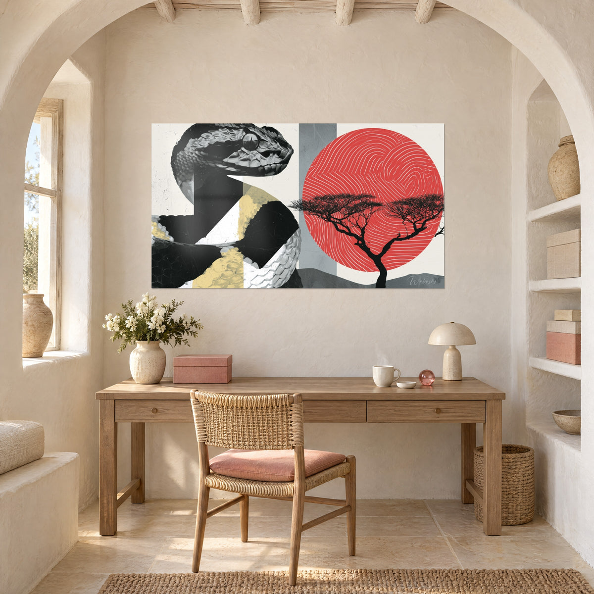 Wall art of a black, white and yellow scaled reptile, red circle engraved with white swirls, black acacia, above a wooden desk