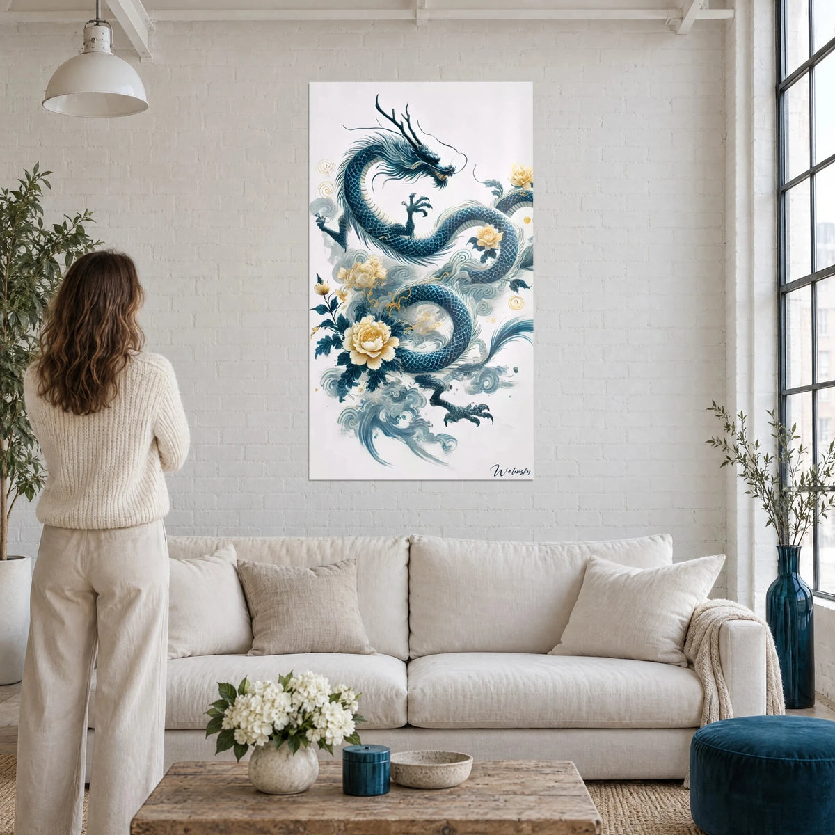 Wall art of a midnight-blue ink dragon coiled among cream and gold peonies, above a sofa in a bright living room