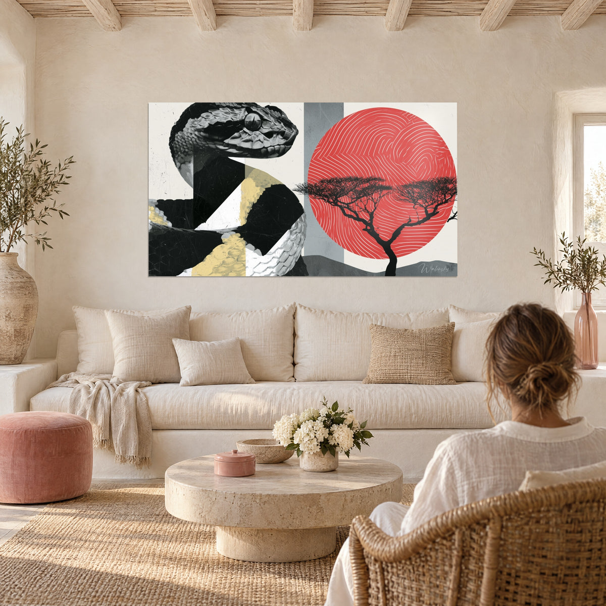 Wall art of a black and ivory snake rearing its head before a red disc, dark acacia, above a sofa in a bright living room