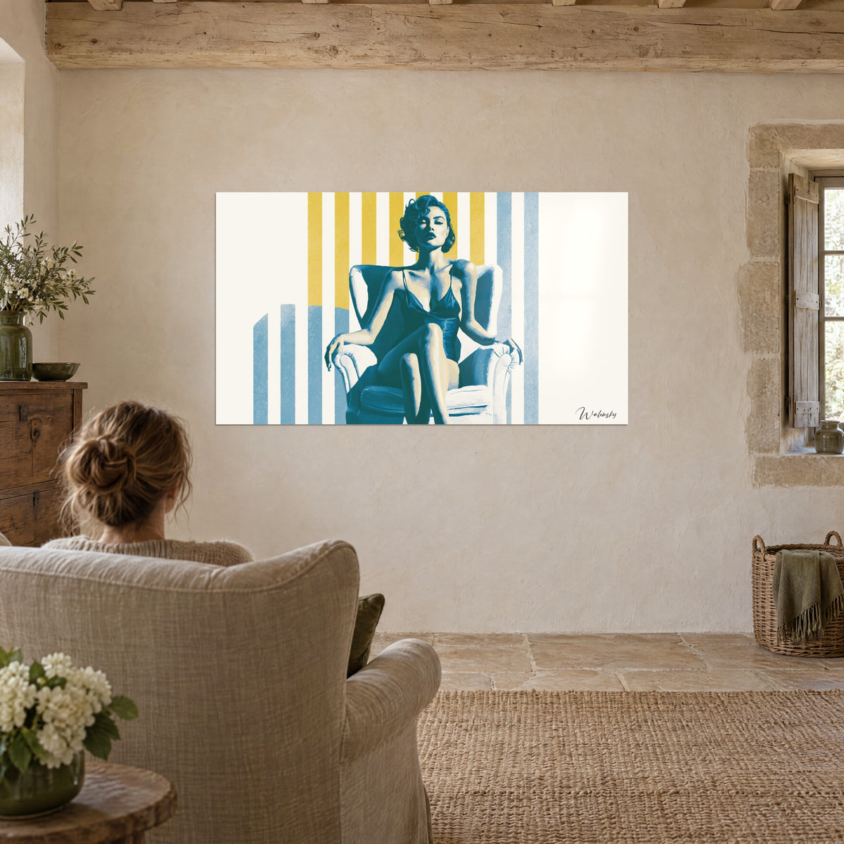 Wall art young femme fatale with crossed leg, blue tones and golden yellow camaïeu, facing a linen armchair in a living room with stone walls