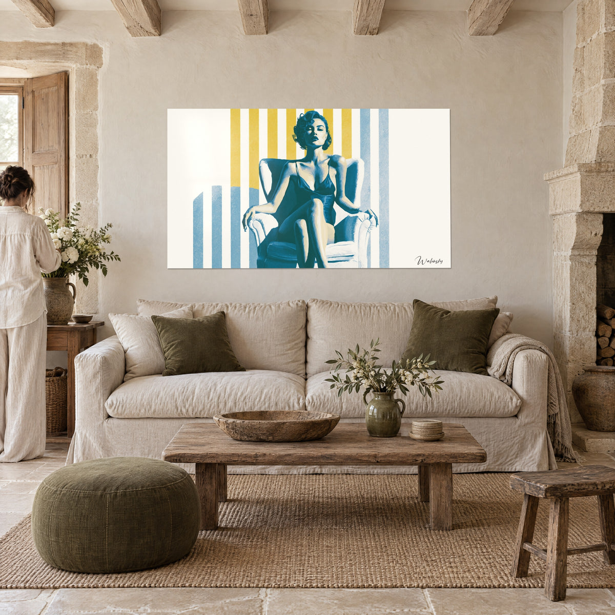 Wall art pin-up in duck blue shorts, seated in a white armchair against a yellow striped background, above a sofa in a bright living room