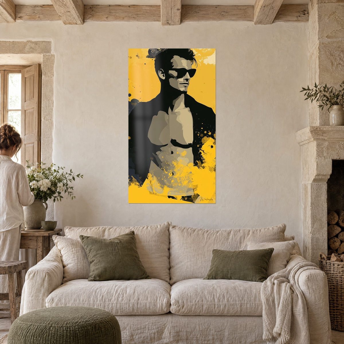 Wall art shirtless man in black sunglasses, open jacket, yellow splashes, two people seen from behind above a sofa in a bright living room
