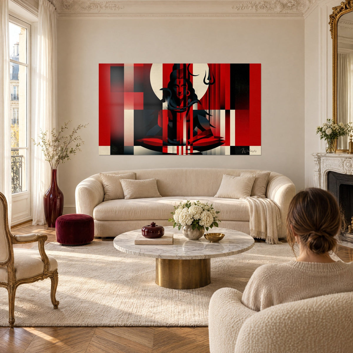 Wall art meditating deity in lotus pose, bright red and black bands on an ivory disc, trident and cobra, above a sofa in a bright living room