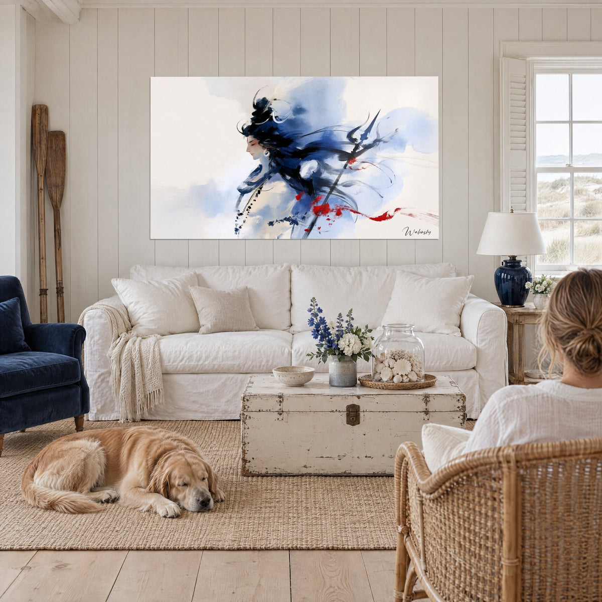 Wall art Shiva in profile with navy-ink hair, trident and red ribbon, above a sofa in a bright living room