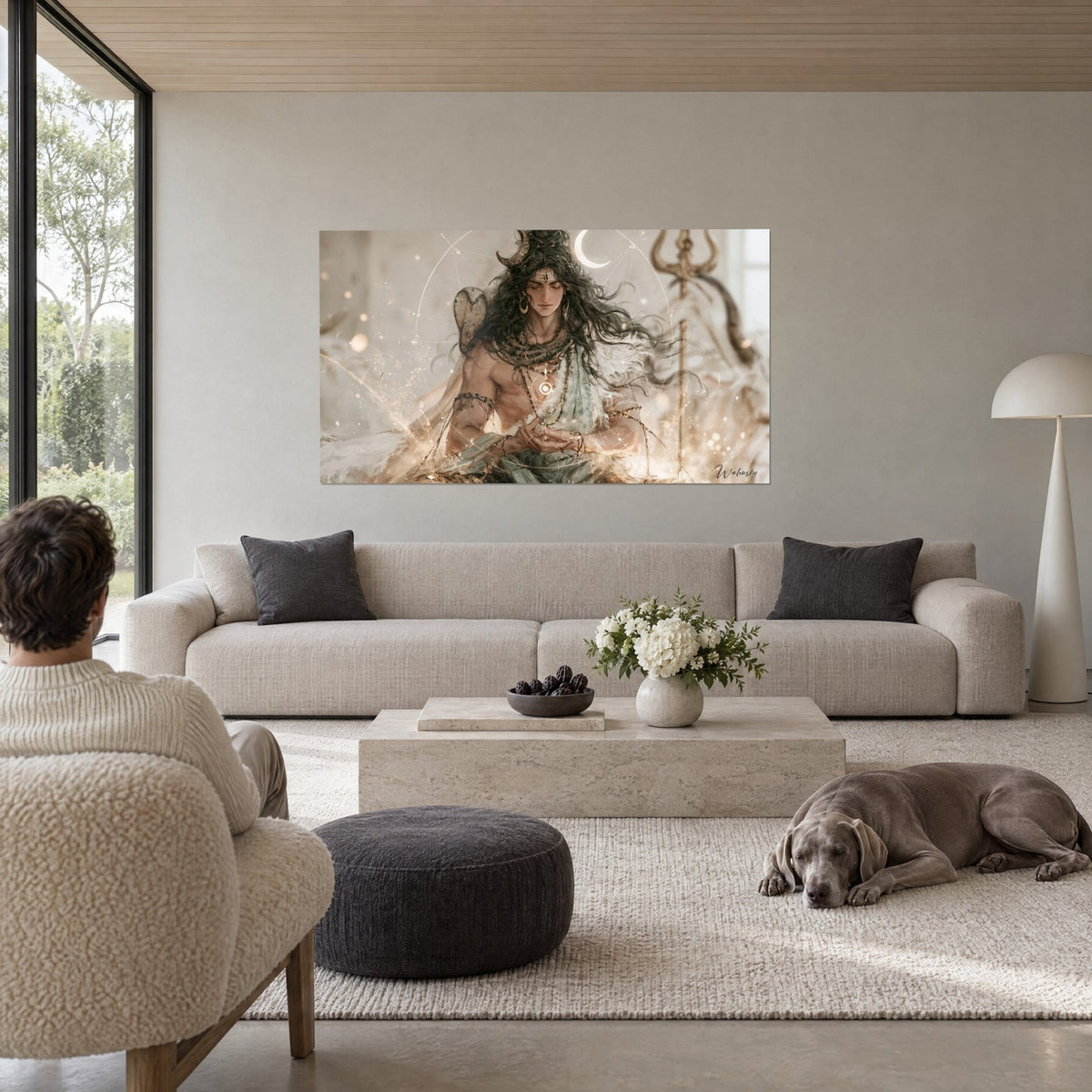 Wall art Shiva meditating with brown curls, white crescent moon and golden trident, above a sofa in a bright living room
