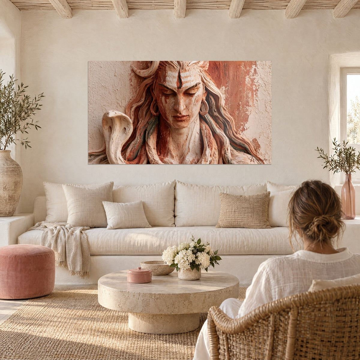 Wall art carved Shiva relief, ochre and terracotta face, cream cobra, above a sofa in a bright living room