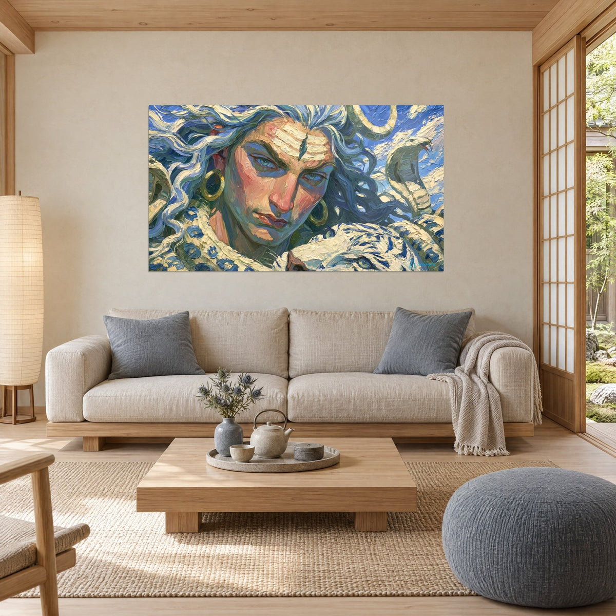 Wall art of a deity with a third eye on the forehead, silver hair and rosy skin, above a sofa in a bright living room