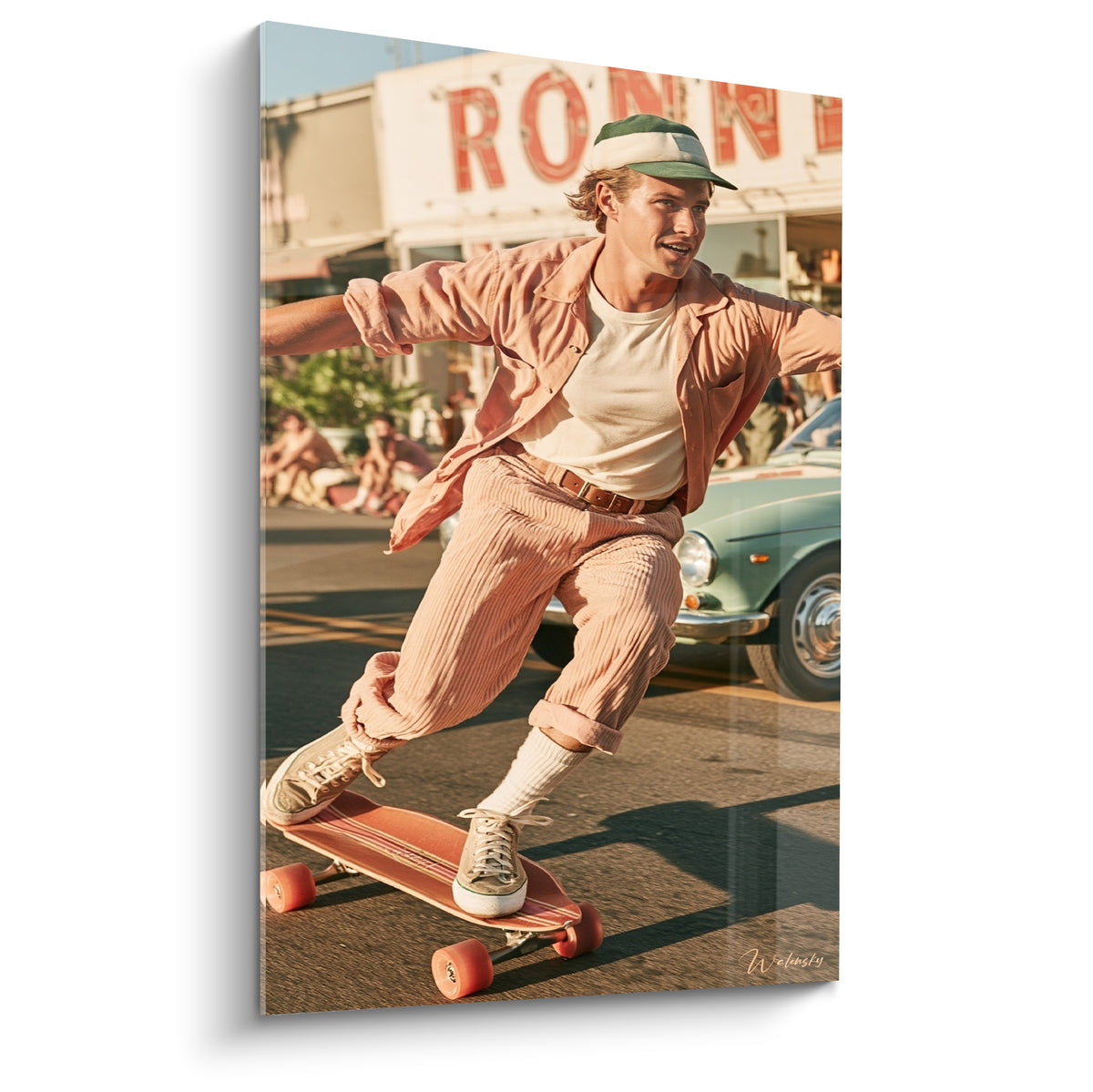 Skateur en veste rose poudré et casquette vert glissant sur une planche aux roues orangées