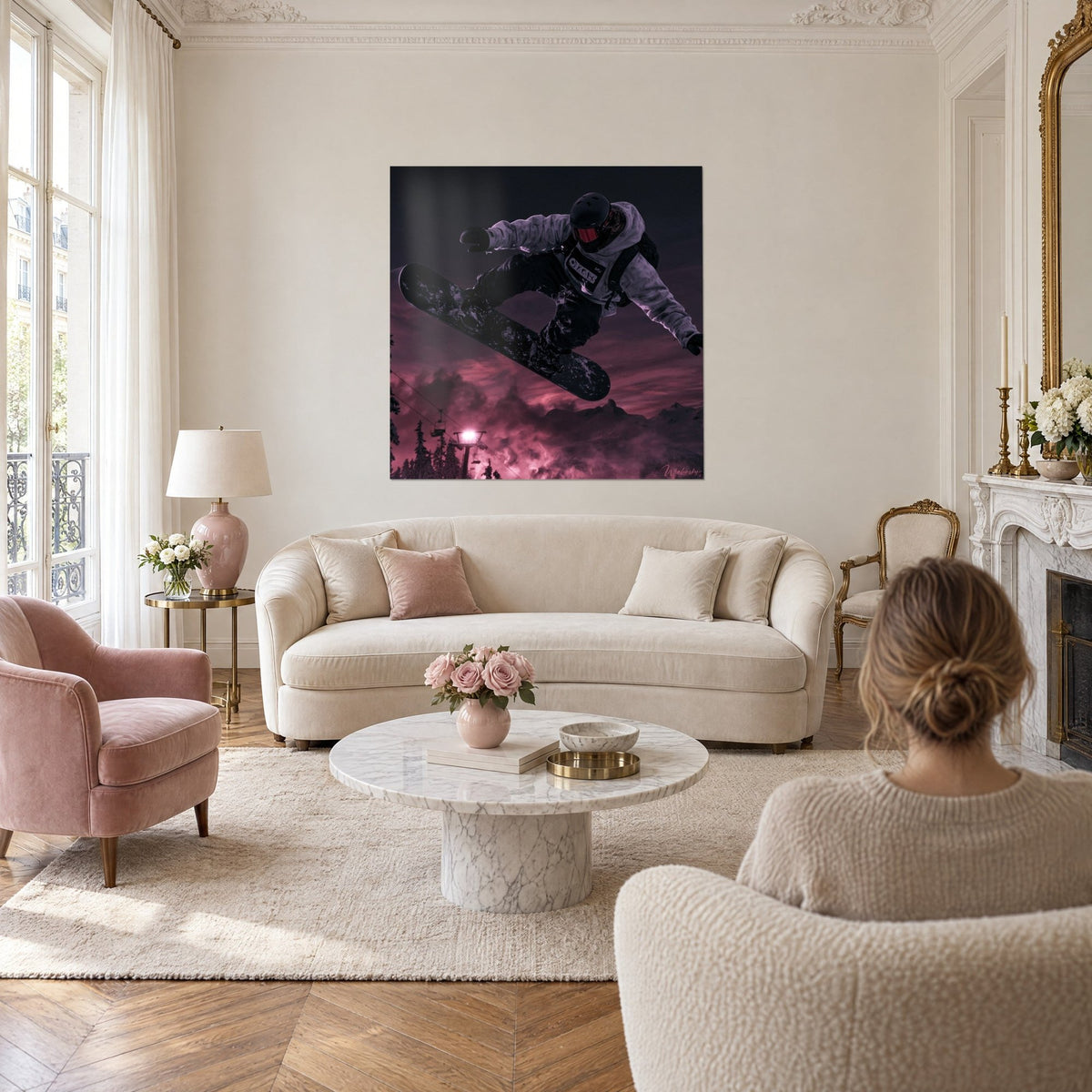 Wall art snowboarder in black helmet and red mask mid-jump, purple sky, above a sofa in a bright living room