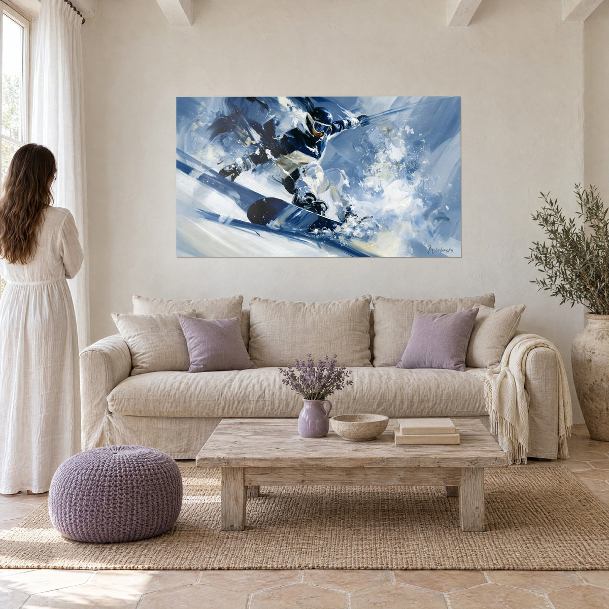 Wall art of a snowboarder carving on the edge, navy and white suit, spray of snow, above a sofa in a bright living room