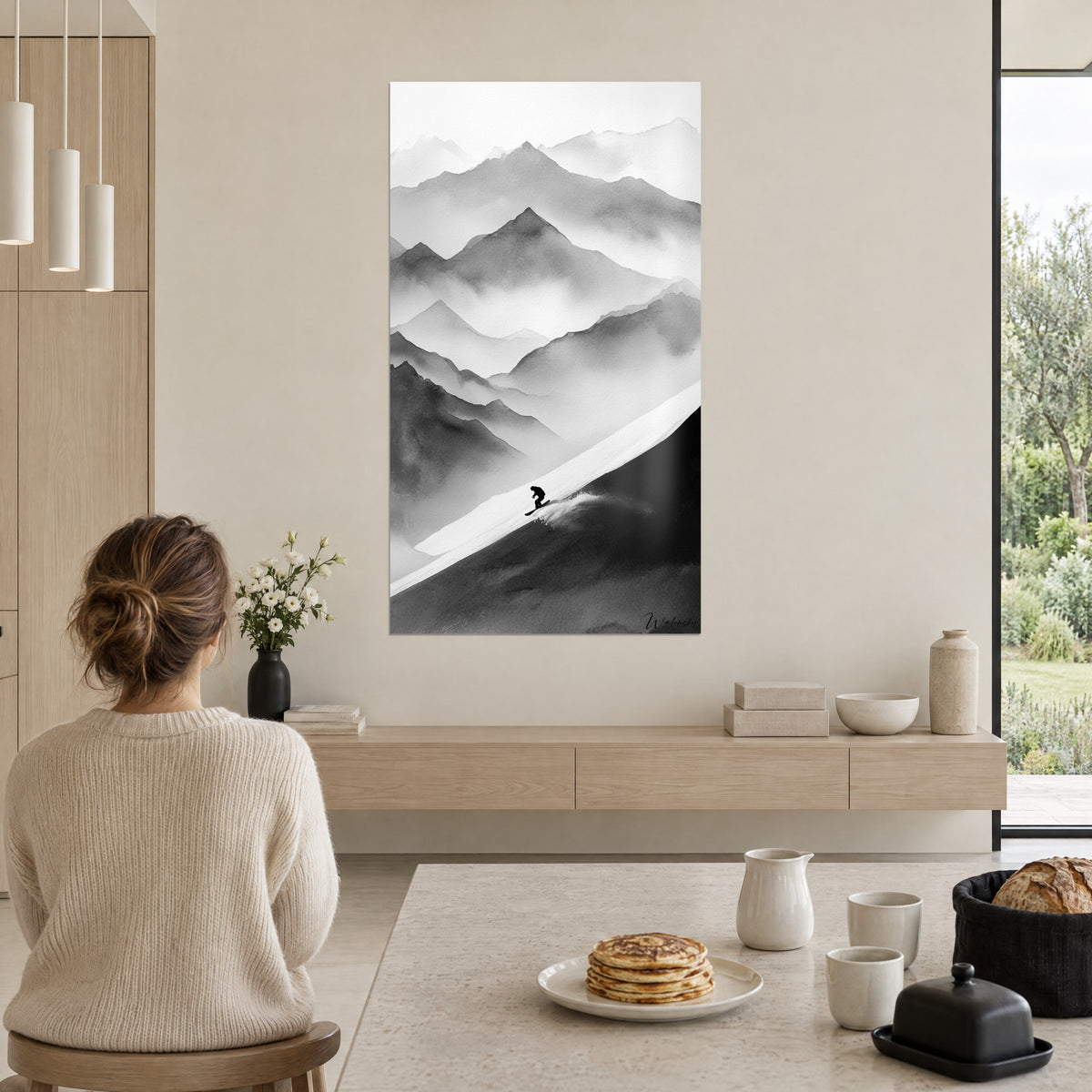 Wall art of an alpine landscape in ink, pale grey peaks in the mist, small black silhouette in fresh powder, viewed from a table