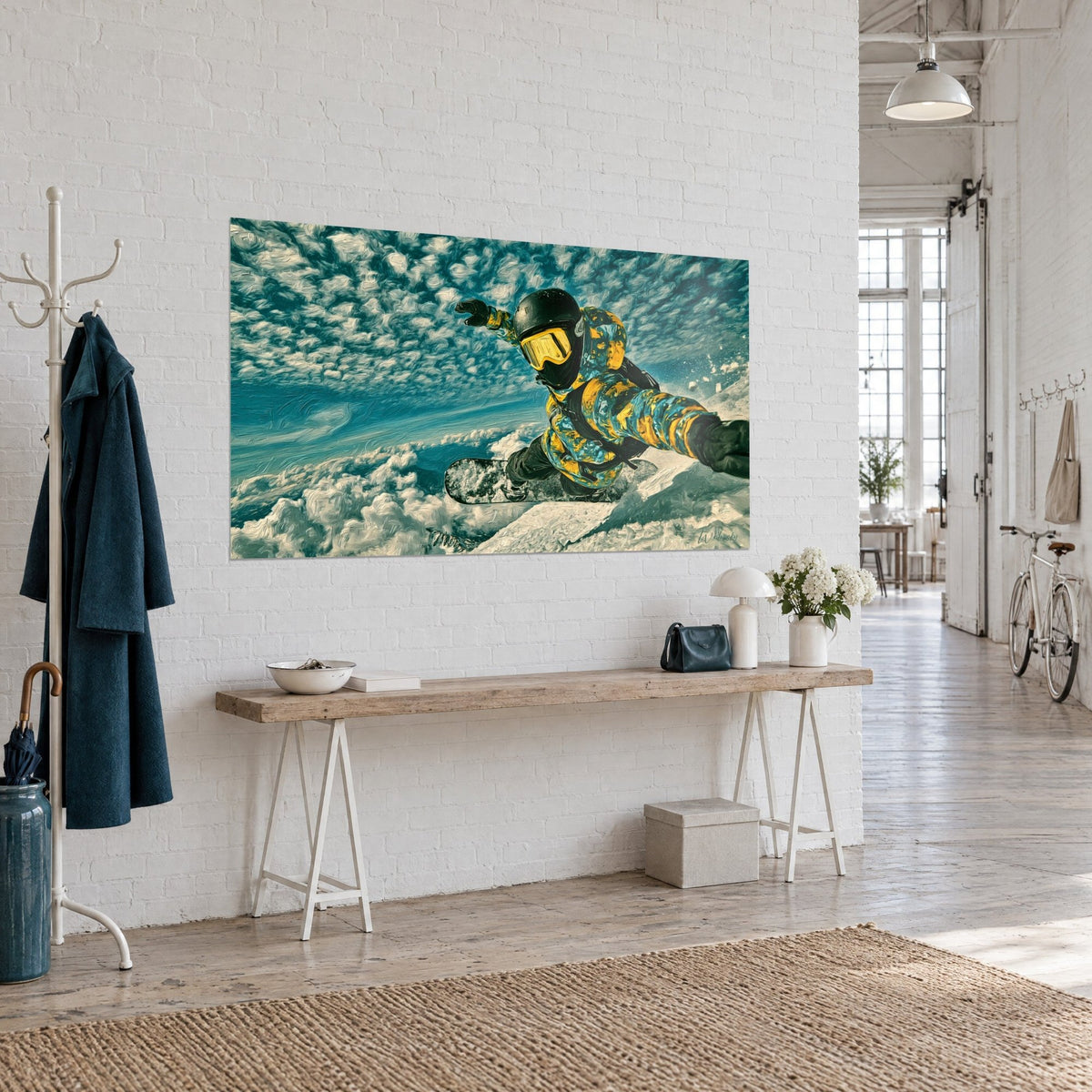 Tableau rider bras tendus dans une veste jaune moutarde et bleu canard, ciel moutonné, accroché en vue de trois-quarts dans l'entrée d'un loft