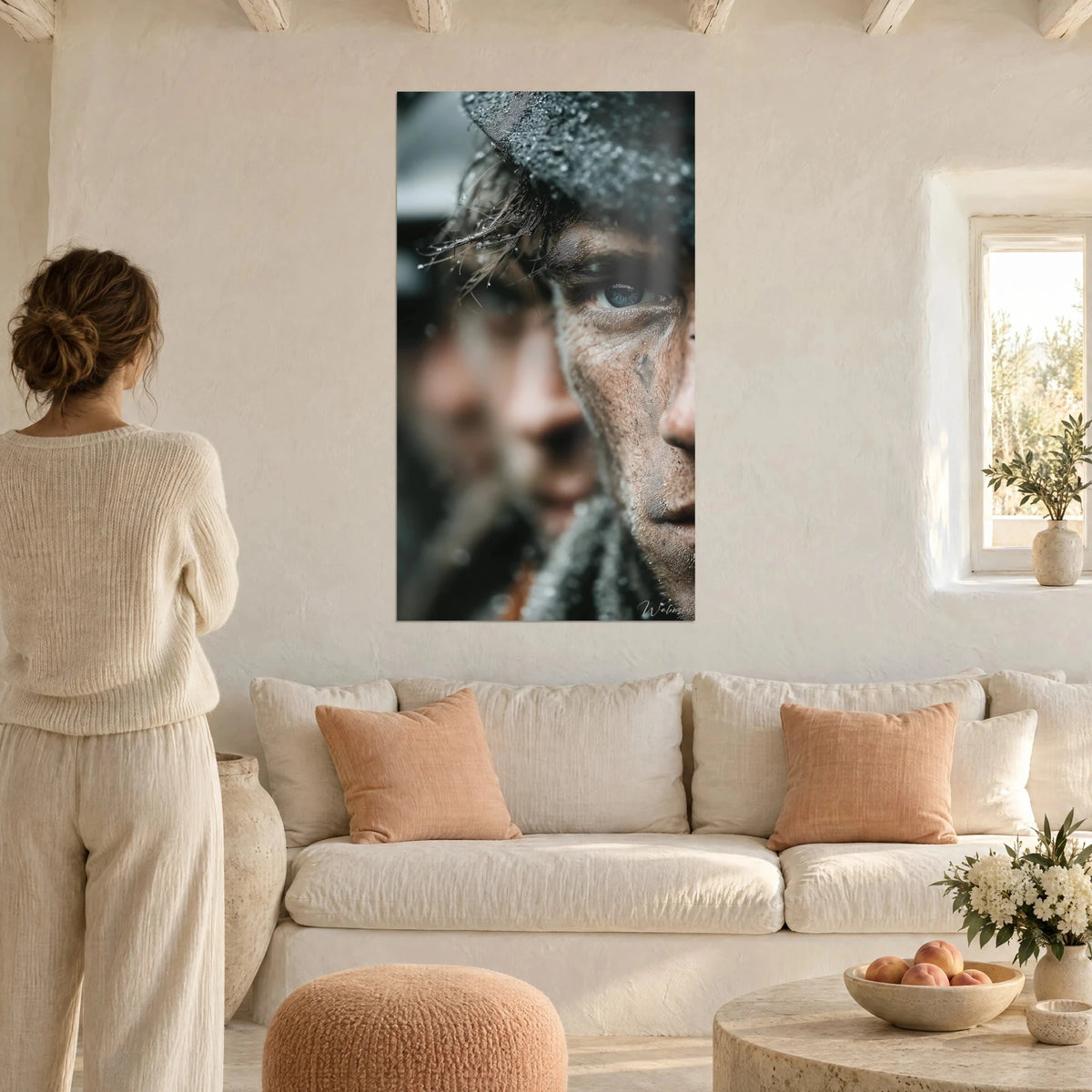 Wall art soldier with steel blue eyes, face covered in brown mud and raindrops, above a sofa in a bright living room