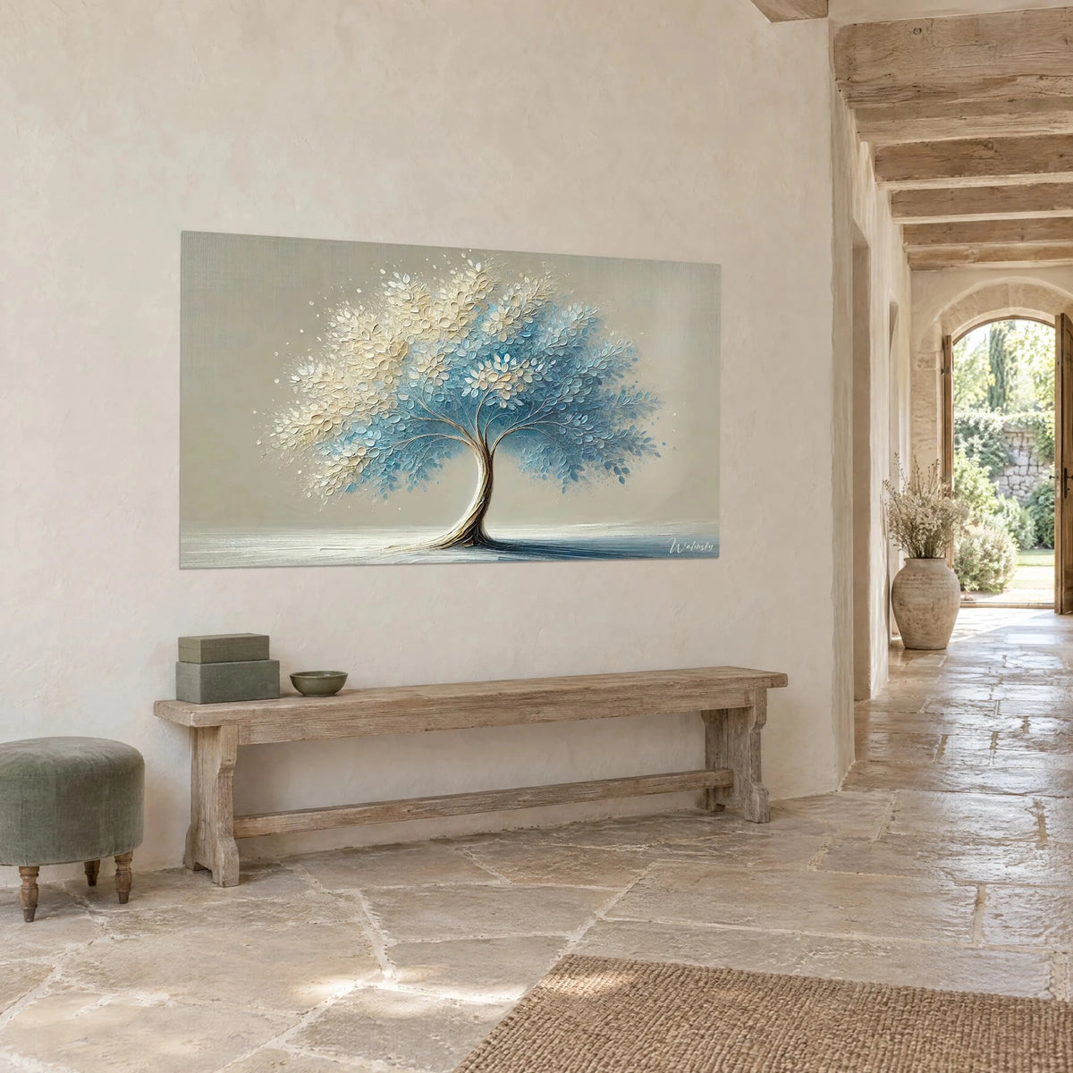 Wall art foliage in powdered cream and azure on a beige background, hung above a wooden bench, stone house
