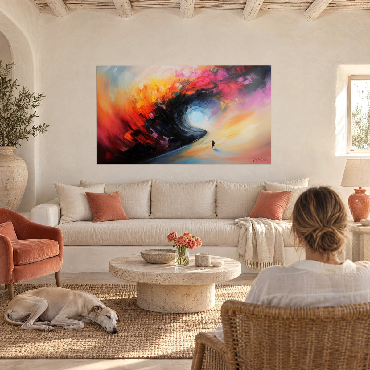 Wall art swirl of orange and pink paint, lone silhouette on a path, above a sofa in a bright living room