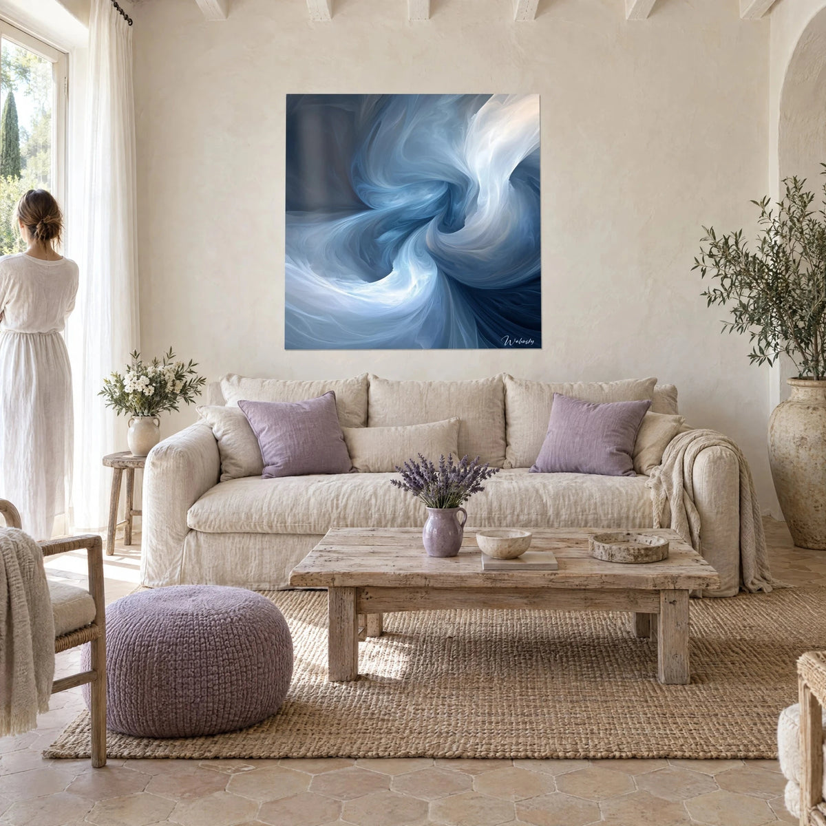 Wall art cobalt blue and pearly white swirl of billowing curves, hung above a sofa in a bright living room