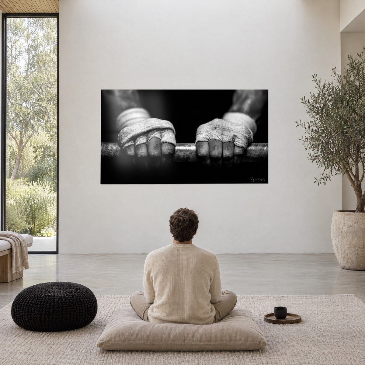 Wall art athlete's hands wrapped in light fabric bands, striped steel bar, black background, in a large minimalist living room