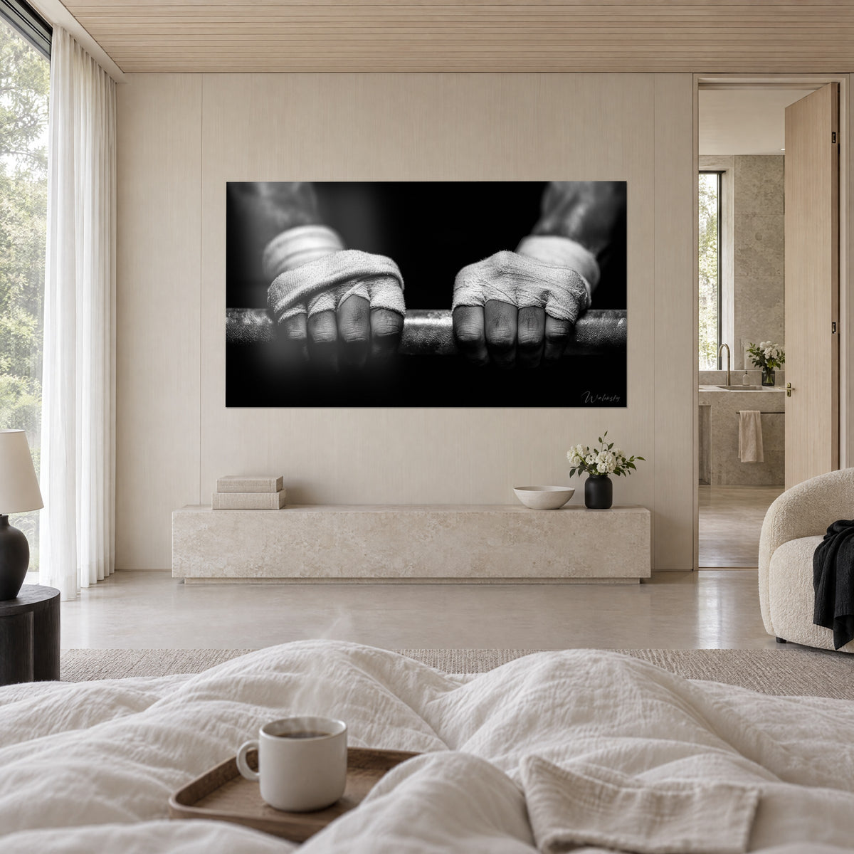 Wall art gnarled fingers clamped on a barbell, worn white gauze, black shadows, above a bed in a bright bedroom