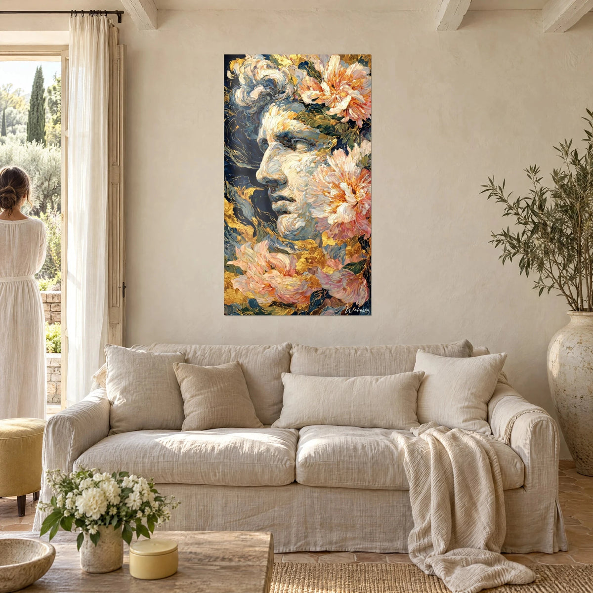 Wall art statue profile in ivory paste and coral pink peonies on a midnight blue background, above a sofa in a bright living room