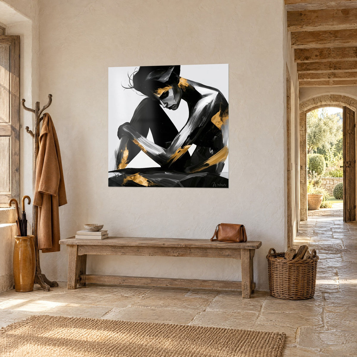 Wall art crouching woman in black and silver brushstrokes, golden highlights, facing a stone arch in a country house