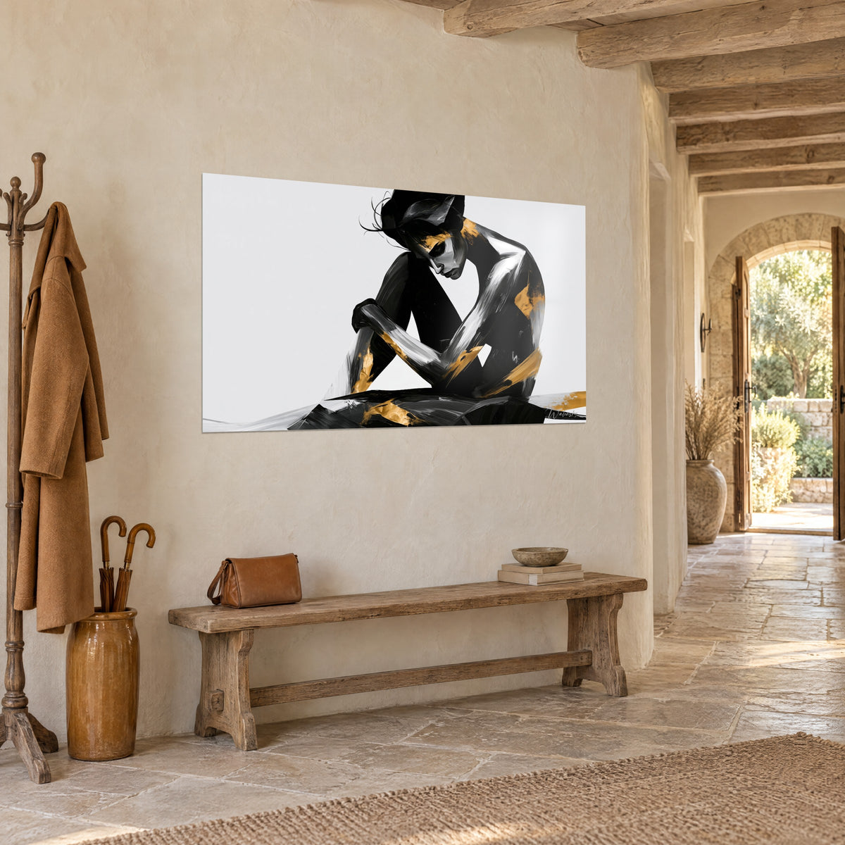 Wall art seated figure with bowed head, black painting streaked with silver and touches of gold, hung three-quarter view beside a wooden bench